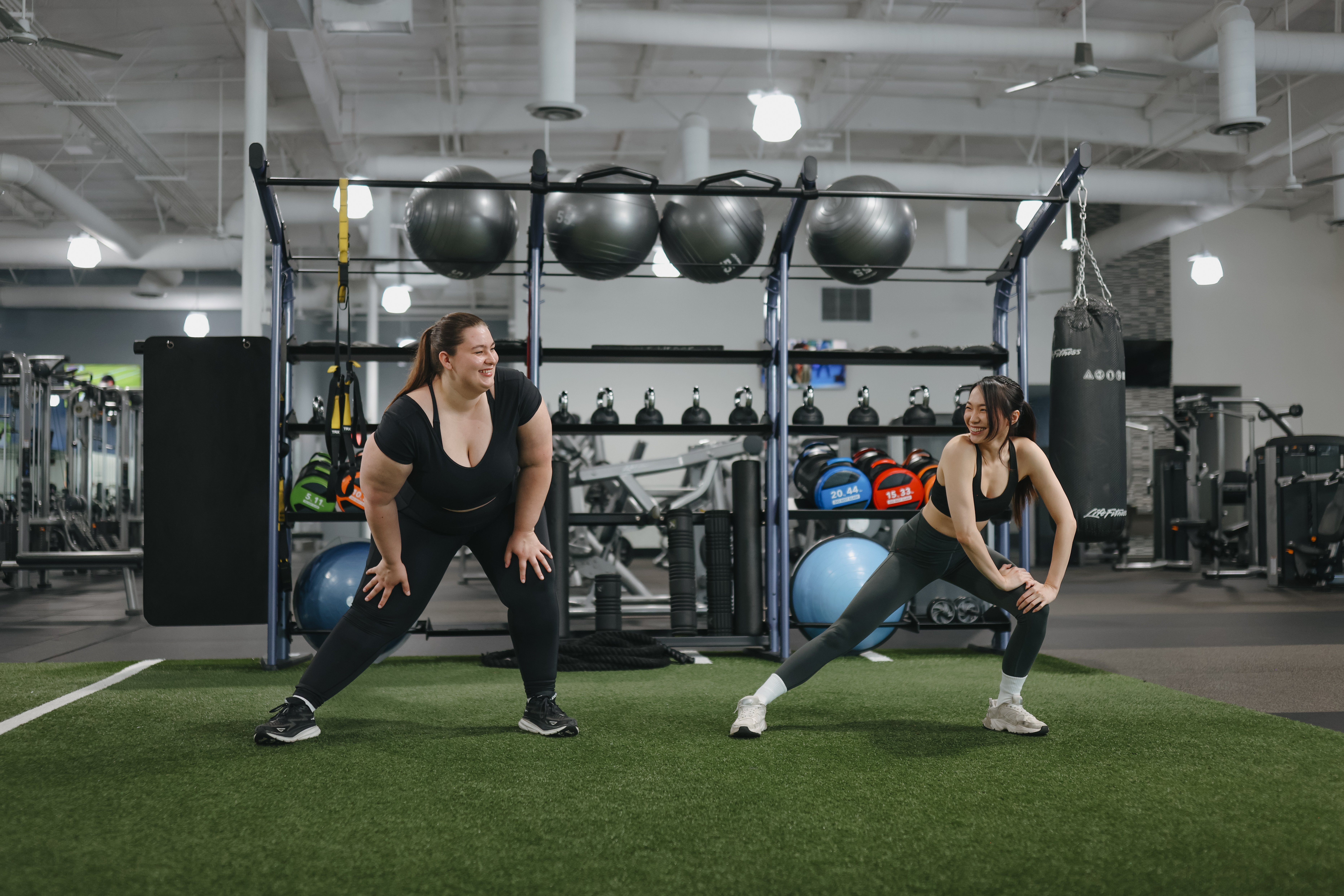 Stretching on the turf at Vim + Vigor Fitness